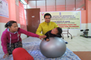 Physiotherapist giving therapy to one of the client