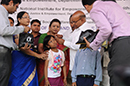 Hon'ble Union Minister Shri. Thaawar Chand Gehlot, M.S.J&E, G.O.I, distributing hearing aid to one of the beneficiaries