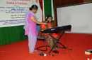 A person with visual impairment performing cultural event during the program.