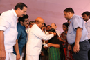 Person with Hearing impaired receiving corner chair from Hon’ble Union Minister.